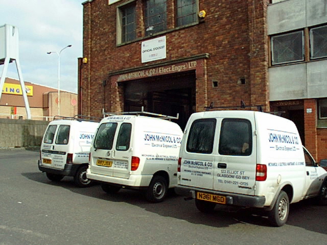 Three white vans, parked neatly on Elliot Street 'cause  its quiet for once.
