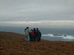 Checking the map, clustered together against the fierce wind