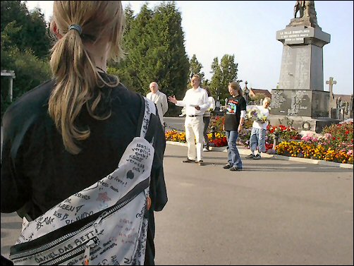 Young people laying flowers to honour the French soldiers buried at Cité Bonjean