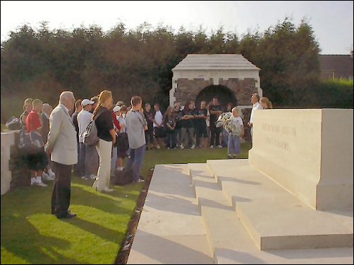 Young people laying flowers to honour the British soldiers buried at Cité Bonjean