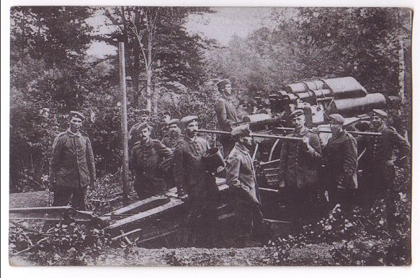 German 21cm heavy mortar in lowered position, in a secluded position in a wood, surrounded by its artillery team.