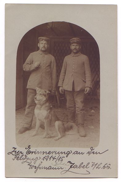 Two soldiers pose formally, side by side.  A large dog sits in front of them.