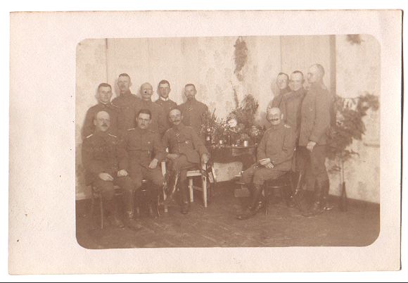 Seated and standing, a group of officers/NCO's gather in one corner of the mess for a posed photograph.