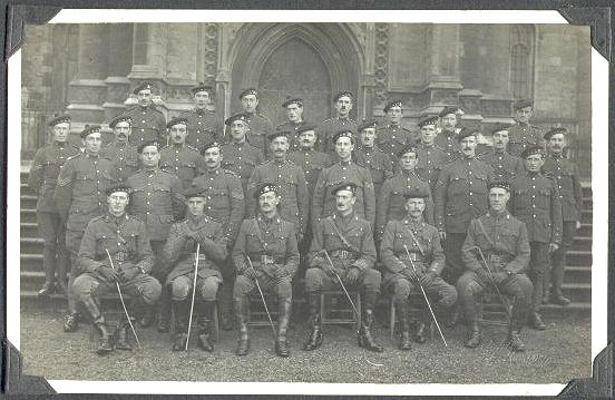 31 men, the NCO's standing in three ranks on the steps of a church (or Ripon cathedral?) with the officers seated at the front.