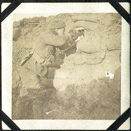 Corporal Smith aims his rifle through a hole in the breastworks.