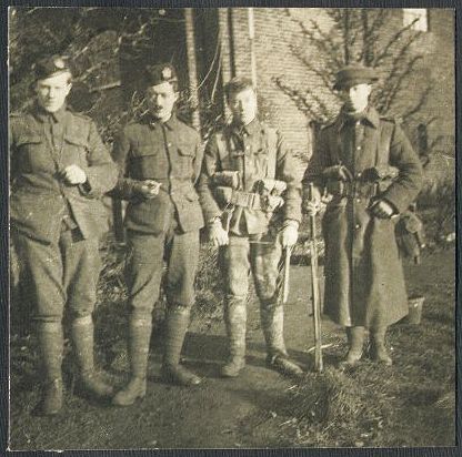 Walter, a friend, Johnny and their father, J. R. L. Smith (senior), stand together for this group photograph, all wearing uniform.