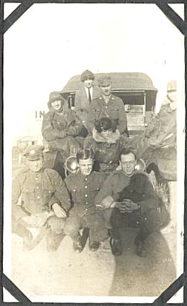 A group of transport staff pose for this photograph in front of a canvas-topped truck.