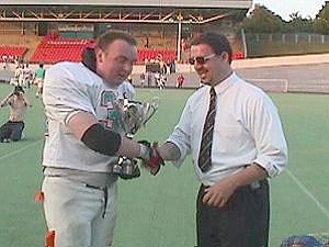 Steve Wooton (5 solos and 1 assist), for so long the heart of the Senators' defense, receives the Championship Trophy on behalf of the team.