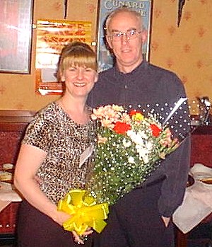 The Schooner Inn's Debbie is presented with flowers by Club Secretary Bill Gibson.