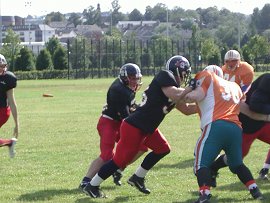 Derek Parry and Steve Wooton close in on Sutherland to make the stop