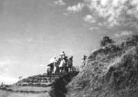 Old lady being carried up to Karli on a litter